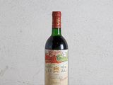 a bottle of wine sitting on a wooden table