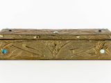 an image of a gold box with blue stones on it