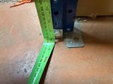 a measuring tape on the floor next to a piece of metal