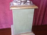 statue of a woman holding a flag on top of a wooden table