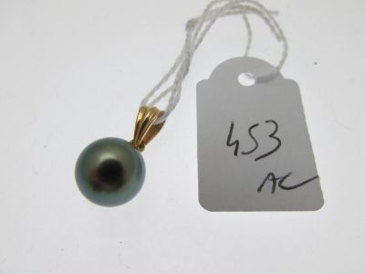 a small black pearl on a string with a price tag