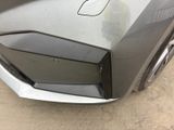 a close up of a car ' s front bumper with a hole in it