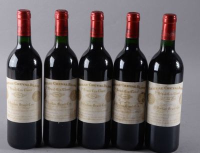 four bottles of wine are lined up in a row