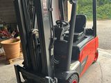 a red forklift truck parked in a garage