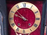 a clock with roman numerals on the face of it