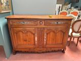 a wooden cabinet that has a door on top of it