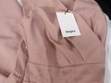 the dress is pink and has a price tag on it