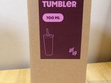 a cardboard box with a drink in it sitting on a table