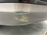 a close up of a car ' s front bumper with scratches on it