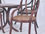 two chairs and a table in a white room