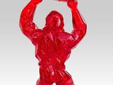 red glass figurine of a man holding a bucket over his head