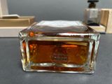 a bottle of perfume sitting on a table next to a box