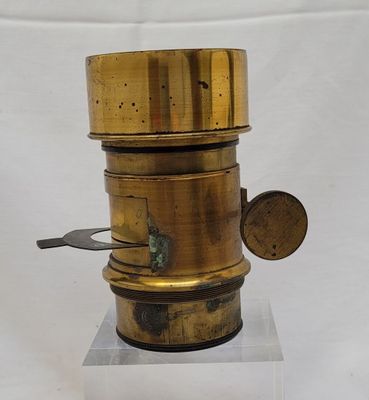 a small brass object on a clear base