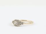 a gold ring with a diamond and a white diamond in the center