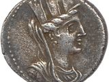 une pièce d'argent sur laquelle figure l'effigie d'une femme coiffée d'un chapeau