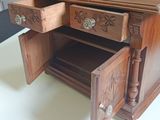 a small wooden desk with two drawers on top of it