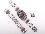 a watch that is sitting next to a metal bracelet