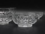 three glass bowls sitting on top of a table next to each other