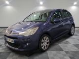 the blue citrole is parked on a checkered floor