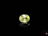 a close up of a green gemstone on a black surface