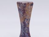a small vase that is sitting on a white surface