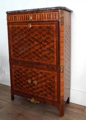 a wooden chest of drawers with a marble top