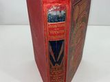 a red book that is open on a white table