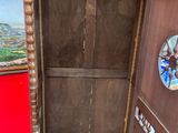 a wooden door that has a mirror on the side of it