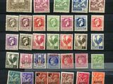 a collection of stamps from different countries on display in a glass case