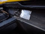 a close up of a yellow car with a license plate on it