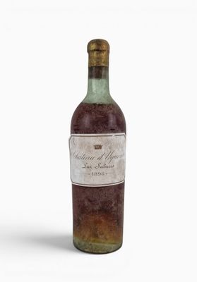 a bottle of wine sitting on top of a white surface