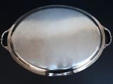 a silver tray with a handle on a black table