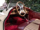 a red and white car with a steering wheel and leather seats