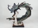 statue of a peacock on a branch with a white background