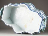 a blue and white bowl with a flower decoration on it
