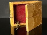 a wooden box with a key in it on a table