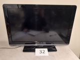 a television that is sitting on a table with a price tag in front of it
