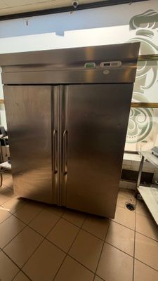 a large stainless steel refrigerator in the middle of a kitchen