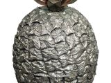 a silver vase with a pineapple on top of it