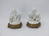 pair of white marble figurines of a boy and a girl