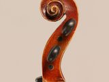 an antique violin with a scroll on the back of it