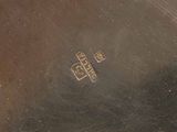 a silver plate with a picture on it on a table