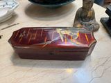 a small box sitting on a table next to a statue