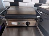 an image of a counter top grill with a purple towel on it