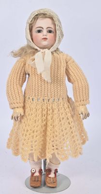 an image of a doll is wearing a yellow dress and a hat