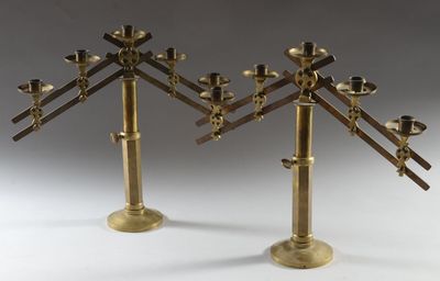 pair of brass candlesticks with candles in the shape of a tree