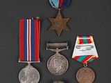 three medals and a medal on a black surface