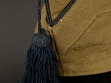 yellow and black hat with a tassel on top of a mannequin head