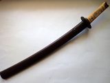 a close up of a knife on a table with a wooden handle