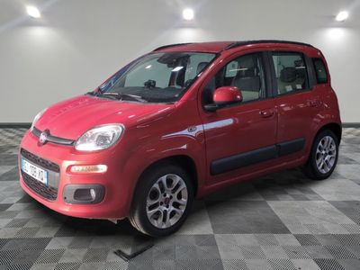 the small red car is parked in the garage on the checkered floor